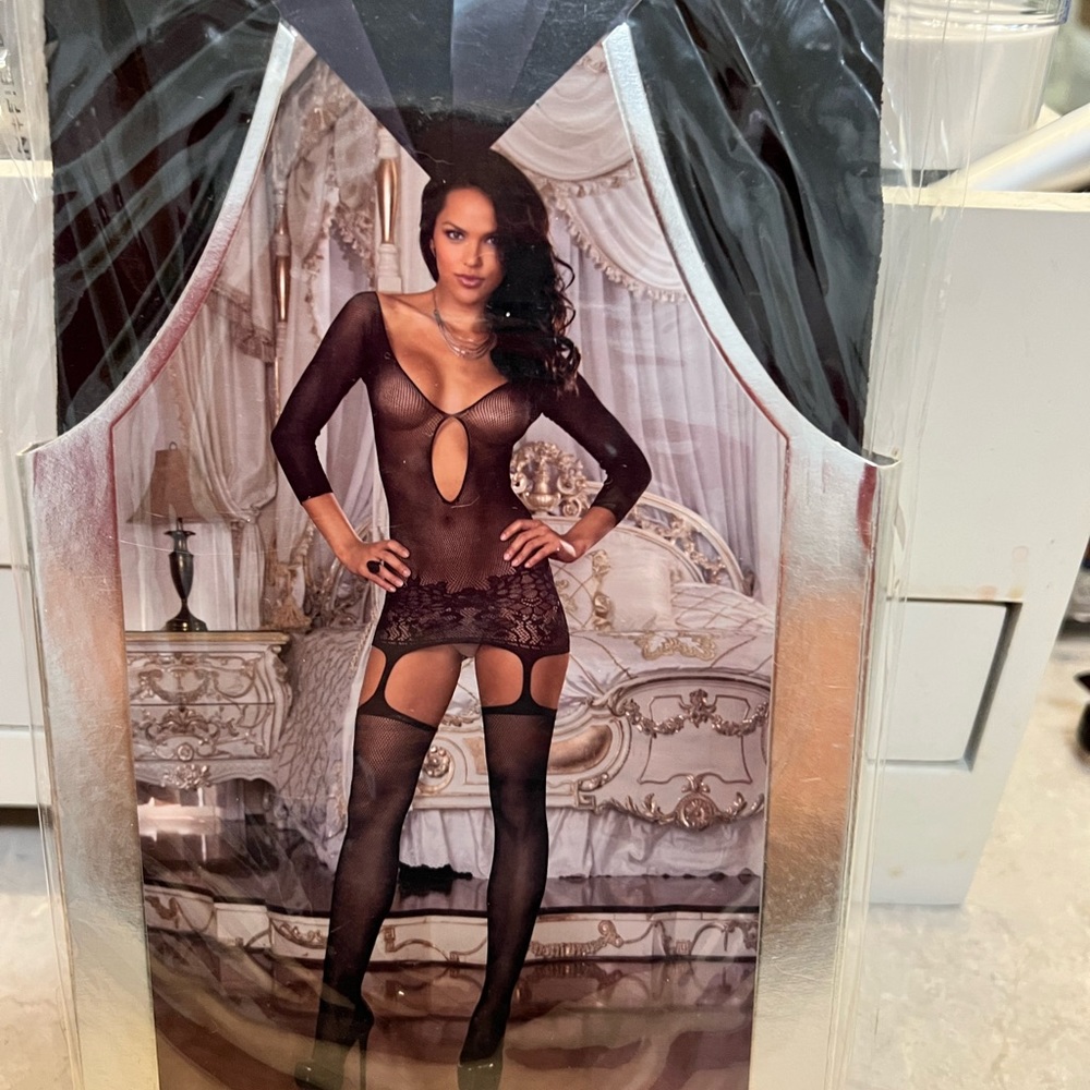 Fishnet garter dress with lace ham and attached matching thigh high stockings.